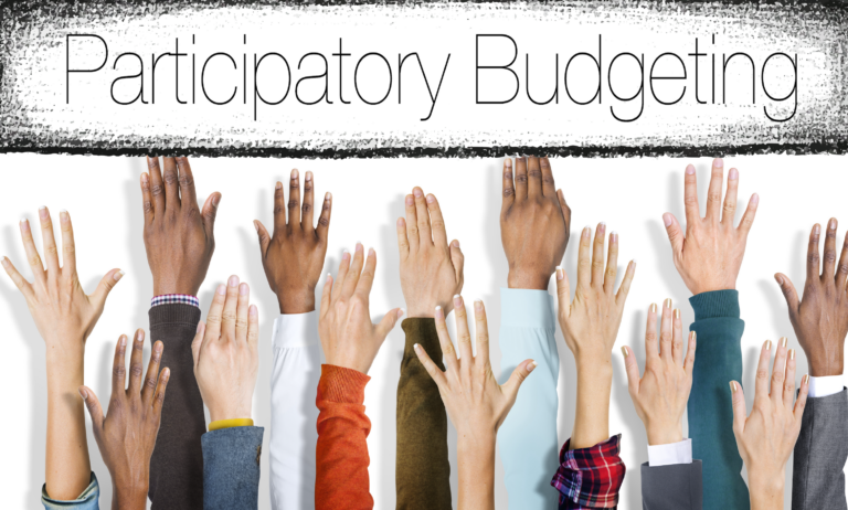 Hands reach toward the phrase "participatory budgeting"