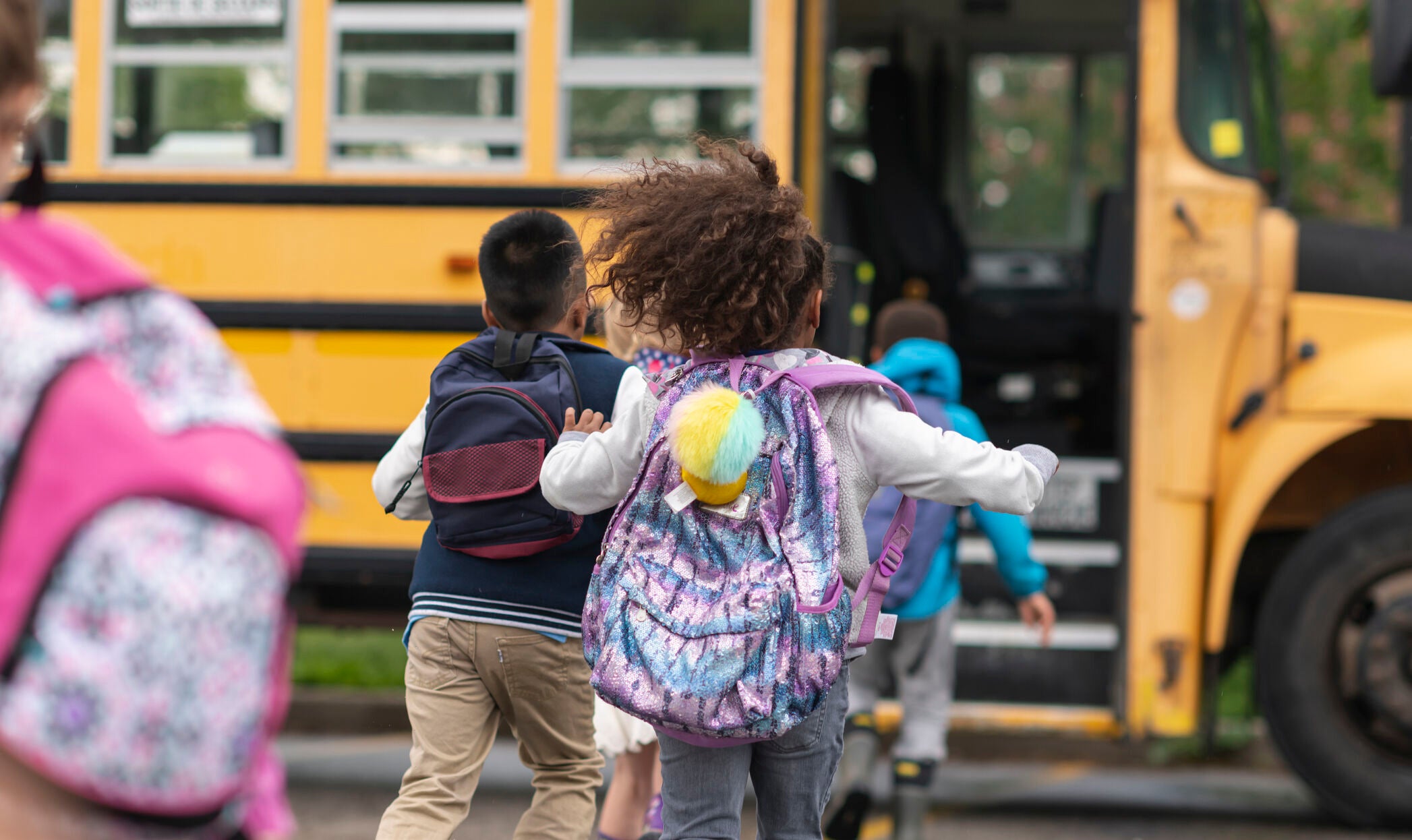 Kids running to catch school bus